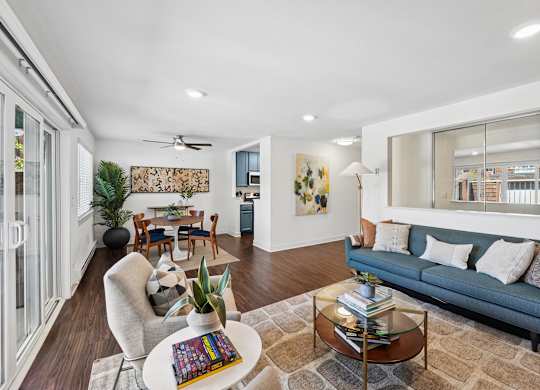 A living room with a blue couch and a coffee table.