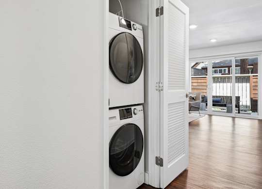 A white washing machine and dryer in a laundry room.