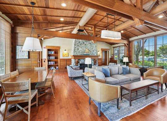 Interior clubhouse seating area with warm wood design and open layout
