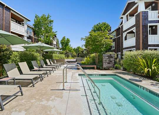 outdoor hot tub surrounded by seating and landscaping