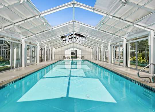 indoor pool house with glass roof panels and natural light