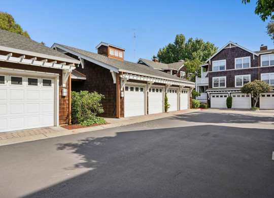 Detached garage parking at Pescadero Apartments with landscaped community surroundings.
