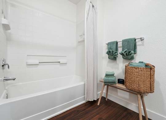 Modern bathroom at Pescadero Apartments with soaking tub, bright finishes, and updated fixtures.