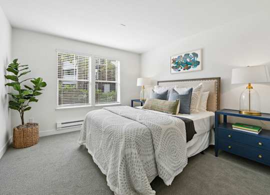 Bright bedroom at Pescadero Apartments with soft finishes, plush carpeting, and spacious closet storage.