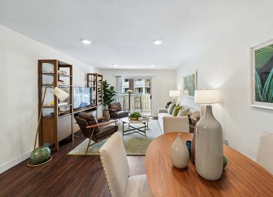 Open-concept dining and living area at Pescadero Apartments with modern furnishings and natural light.