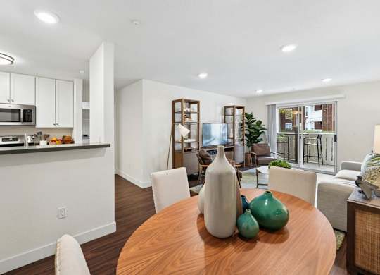 Open-concept dining and living area at Pescadero Apartments with modern furnishings and natural light.