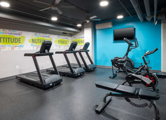 a gym with treadmills and other exercise equipment