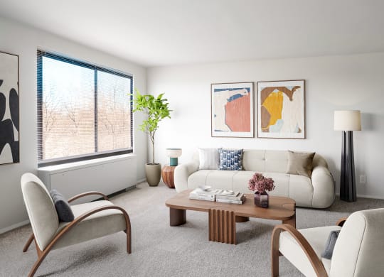 a living room with white furniture and a large window