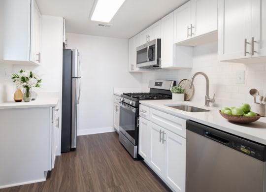 a kitchen with white cabinetry and stainless steel appliances