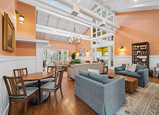 A living room with a grey couch and a wooden table.