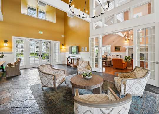Leasing office with welcoming seating, workspaces, and contemporary interior finishes at The Presidio Apartments.
