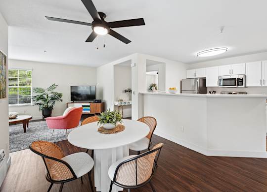 A modern kitchen with a dining table and chairs.
