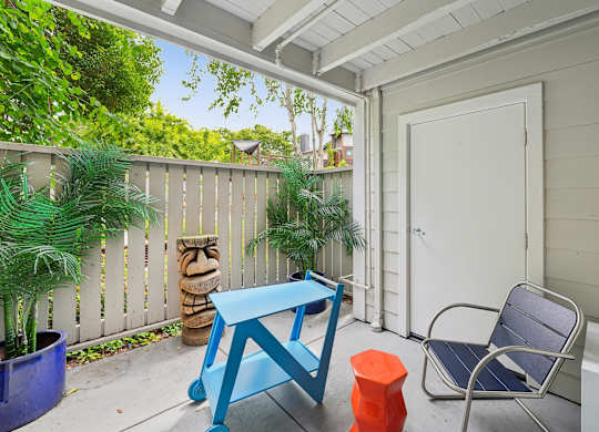 A blue table and chair set on a patio.