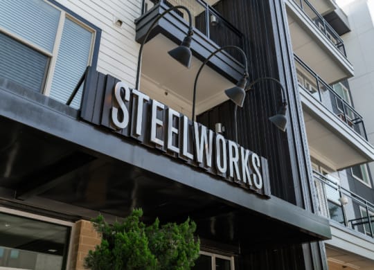 a sign for steelworks on the side of a building