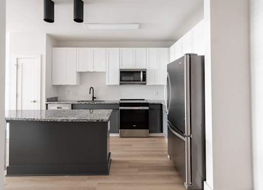 A modern kitchen with a refrigerator on the right.