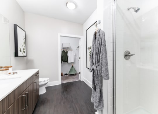 a bathroom with a shower and a sink and a toilet