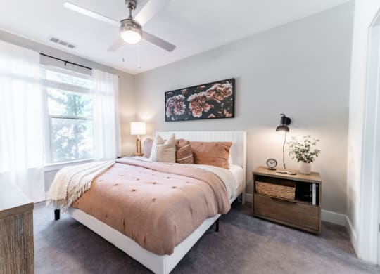 a bedroom with a bed and a ceiling fan