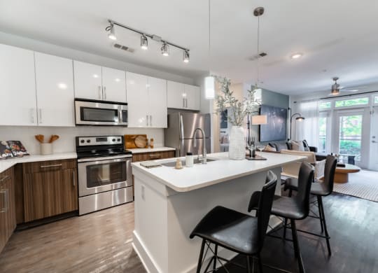 a kitchen and living room with a white counter top