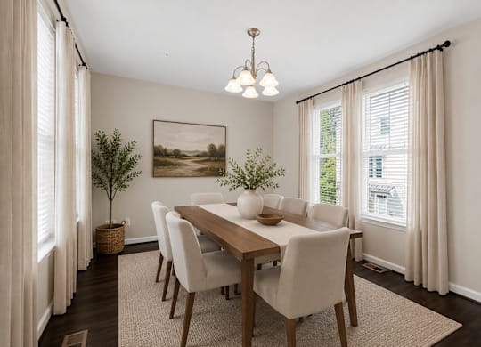 Dining room with large windows, overhead light fixture, and neutral finishes.