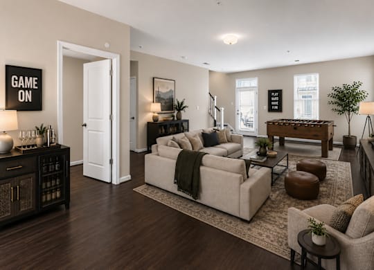 Spacious lower-level living area with open floor plan, large windows, and access to outdoor entry.