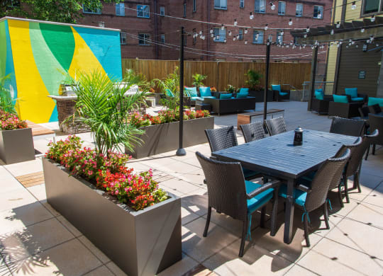a patio with a table and chairs and a large colorful mural