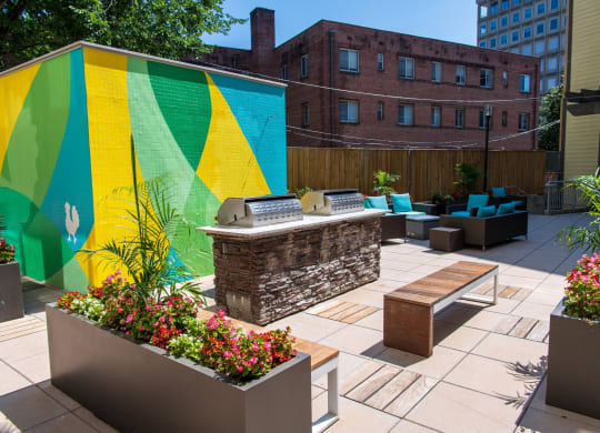 a patio with furniture and a large mural