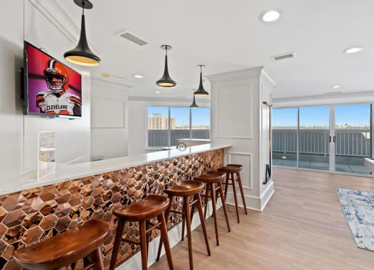 a bar with wooden stools in a room with a pool table