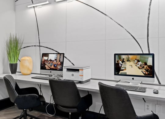 a desk with two computer monitors on it