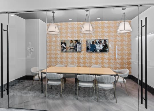 a dining room with a wooden table and chairs