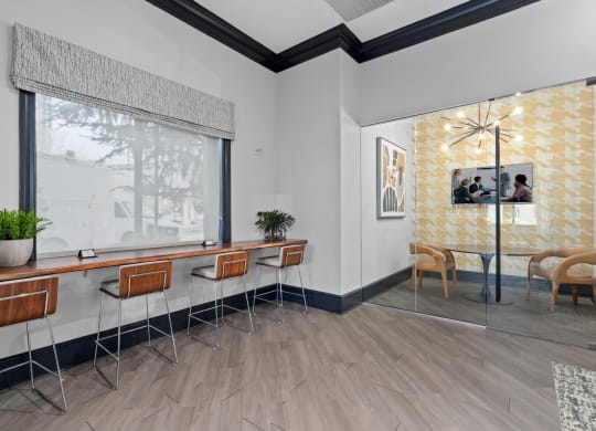 a seating area in a room with a large window and wooden floors
