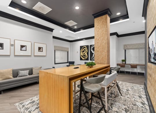 a conference room with a wooden desk and chairs