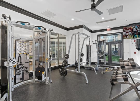 a home gym with weights and a ceiling fan