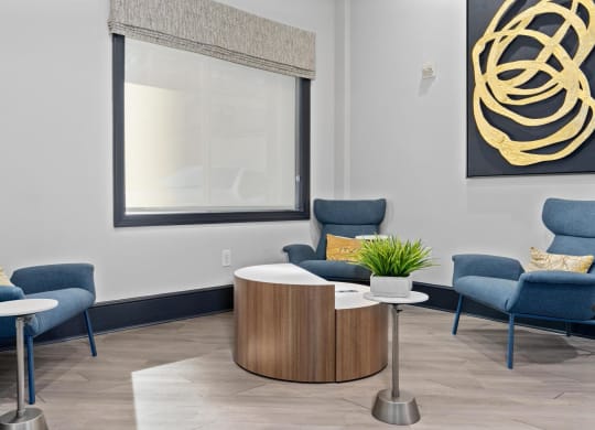 a waiting room with chairs and a table and a window