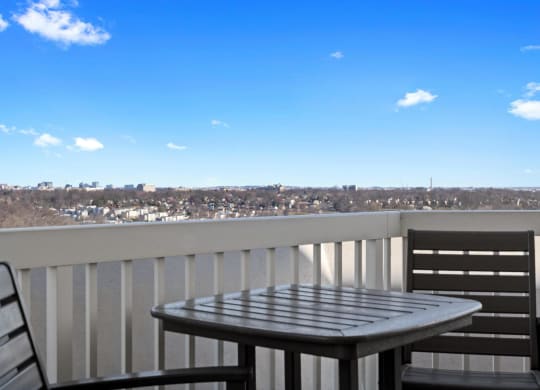 a view of the city from a balcony with a table