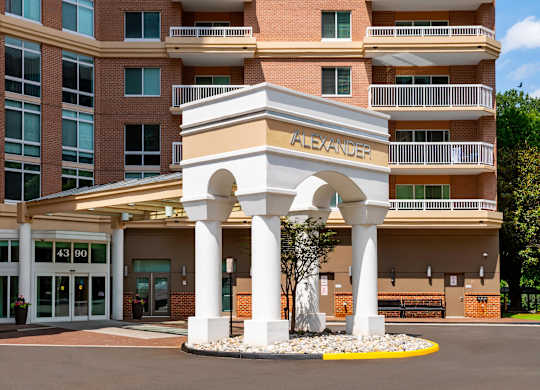 Alexander apartment building with a white arched entrance.