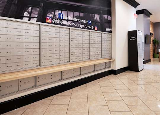 A wall of mailboxes with the numbers 1001 to 1011 on them.