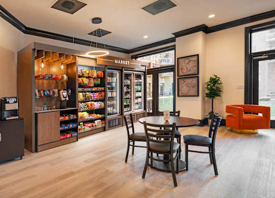 A modern kitchen with a wooden floor and a dining table with chairs.