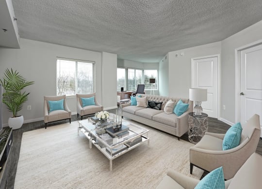 a living room with couches and chairs and a table