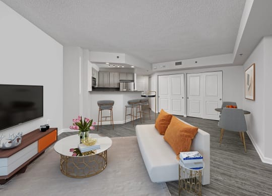 a living room and kitchen with a couch and a table
