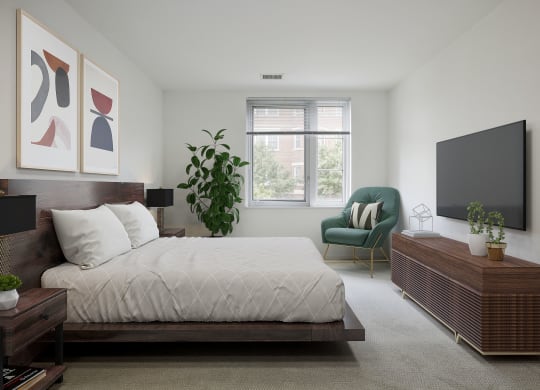 a bedroom with white walls and a large bed with a wooden frame