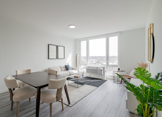 a living room and dining room with a table and chairs
