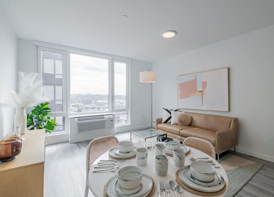 a living room with a table and a couch and a window