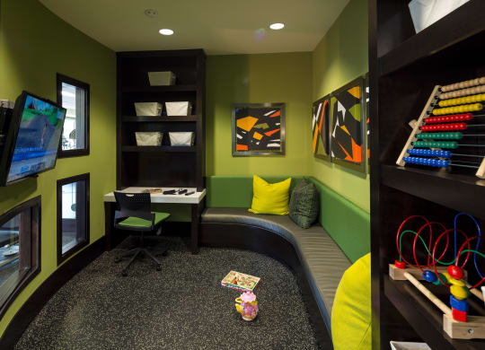 a childs play room with a desk and a chair