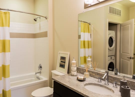 a bathroom with a shower sink and a tub and a mirror