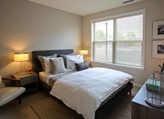 a bedroom with a large bed and a window