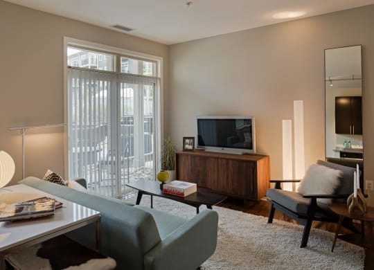 a living room with a couch and a table and a television
