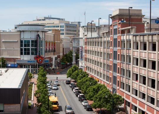 an aerial view of a city street with cars and buildings