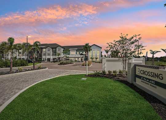 Entrance to The Crossing at Palm Aire during sunset