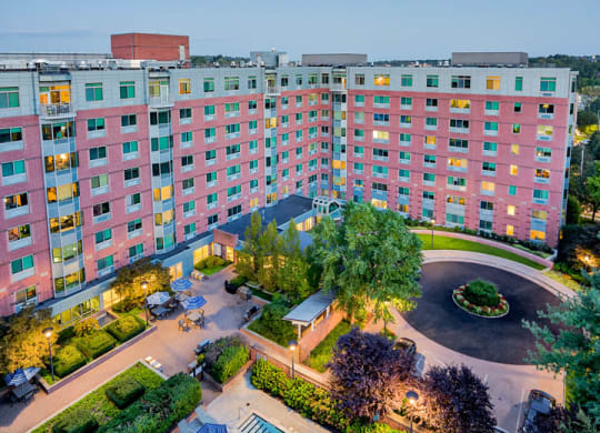 an aerial view of a hotel with a swimming pool