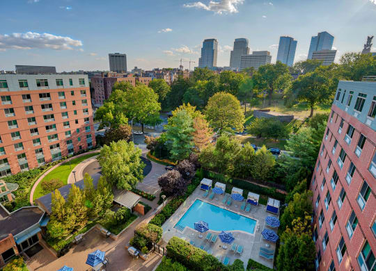 a view of the pool and the city from a hotel room